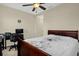 Comfortable bedroom with neutral walls, ceiling fan, and a patterned comforter on the bed at 2261 Brookridge Trl, Sanford, FL 32773