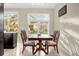 Dining area with wooden table and chairs near a large window, and tile flooring at 2261 Brookridge Trl, Sanford, FL 32773