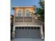 Two-story home with gray painted garage door and a balcony on the second story at 2261 Brookridge Trl, Sanford, FL 32773