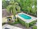 An elevated view of a community pool with palm trees and seating, near a lake at 2261 Brookridge Trl, Sanford, FL 32773