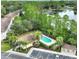Aerial view of a community pool surrounded by lush landscaping and parking, near lake at 2261 Brookridge Trl, Sanford, FL 32773