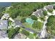 Aerial view of a residential neighborhood featuring a tennis court, mature trees and well-maintained homes at 235 S Shadowbay Blvd, Longwood, FL 32779