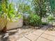 Private backyard featuring a concrete patio and tropical landscaping, creating a serene outdoor space at 235 S Shadowbay Blvd, Longwood, FL 32779