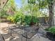 Cozy backyard area with mature trees and an iron table and chair set, perfect for outdoor relaxation at 235 S Shadowbay Blvd, Longwood, FL 32779