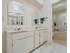 Bathroom featuring dual sinks, white cabinets, and a view of the bathtub at 235 S Shadowbay Blvd, Longwood, FL 32779