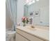 Bright bathroom featuring a bathtub with shower and a vanity with a decorative floral arrangement at 235 S Shadowbay Blvd, Longwood, FL 32779