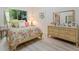 Bright bedroom decorated with wooden furniture, colorful floral bedding, and a view of the garden at 235 S Shadowbay Blvd, Longwood, FL 32779