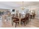 Open dining room featuring a large table, elegant chandelier, and a mirrored wall enhancing the space at 235 S Shadowbay Blvd, Longwood, FL 32779