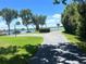 Scenic driveway leading to a lakefront property with lush landscaping and stunning water views at 235 S Shadowbay Blvd, Longwood, FL 32779