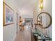 Bright entryway featuring wood-look flooring, decorative mirror, console table, and a glimpse into the living areas at 235 S Shadowbay Blvd, Longwood, FL 32779