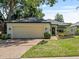 Charming single-story home featuring a well-maintained lawn, mature trees, and an attached two-car garage at 235 S Shadowbay Blvd, Longwood, FL 32779