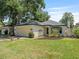 A well-manicured lawn surrounds this charming single-story home, which features a spacious two-car garage at 235 S Shadowbay Blvd, Longwood, FL 32779