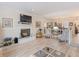 Spacious living room featuring a fireplace, television, comfortable seating, and views into the dining area at 235 S Shadowbay Blvd, Longwood, FL 32779