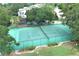 Overhead view of fenced tennis court; a perfect outdoor activity space surrounded by trees and landscaping at 235 S Shadowbay Blvd, Longwood, FL 32779