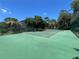 Spacious and well-maintained tennis court surrounded by trees, providing a great recreational amenity at 235 S Shadowbay Blvd, Longwood, FL 32779