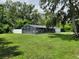 Home with large screened-in pool area, lush backyard, mature landscaping and fencing at 2417 Yale Ave, Sanford, FL 32771
