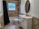 Cozy bathroom with tiled walls, a toilet, and a vanity sink with storage at 2417 Yale Ave, Sanford, FL 32771