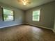Bright, neutral-toned bedroom with ceiling fan and natural light from the windows at 2417 Yale Ave, Sanford, FL 32771