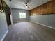 Large carpeted bedroom featuring a ceiling fan and a large window offering natural light at 2417 Yale Ave, Sanford, FL 32771