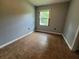 This bedroom has tile floor and a window providing views of the surrounding area at 2417 Yale Ave, Sanford, FL 32771