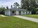 Single story home featuring a white brick facade, and a well-manicured front yard at 2417 Yale Ave, Sanford, FL 32771