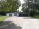 Detached garage featuring multiple bays and an attached carport with a long driveway at 2417 Yale Ave, Sanford, FL 32771