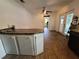 Spacious eat-in kitchen with wood flooring, counter seating, and access to outdoor patio at 2417 Yale Ave, Sanford, FL 32771