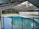 Beautiful in-ground screened-in pool is surrounded by a safety fence at 2417 Yale Ave, Sanford, FL 32771