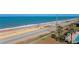 Aerial view of a beach road with an ocean view, palm trees, and a swimming pool at 2700 Ocean Shore Blvd # 515, Ormond Beach, FL 32176