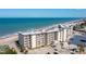 Exterior aerial view of the condo building with ocean and parking at 2700 Ocean Shore Blvd # 515, Ormond Beach, FL 32176