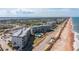 Wide aerial shot showcasing condo, pool, and oceanfront location at 2700 Ocean Shore Blvd # 515, Ormond Beach, FL 32176