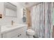 Bright bathroom featuring a shower-tub, toilet, and vanity with storage and a mirror at 2700 Ocean Shore Blvd # 515, Ormond Beach, FL 32176