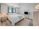 Bedroom features a white-covered bed, a cozy rug, and coastal-themed decorations at 2700 Ocean Shore Blvd # 515, Ormond Beach, FL 32176