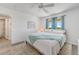 Bright bedroom with a white-covered bed, wood floors, blue curtains, and coastal décor at 2700 Ocean Shore Blvd # 515, Ormond Beach, FL 32176