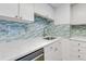 Kitchen featuring white countertops, stainless steel appliances, and designer backsplash at 2700 Ocean Shore Blvd # 515, Ormond Beach, FL 32176