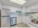 Bright kitchen featuring white cabinets, stainless steel appliances, and designer backsplash at 2700 Ocean Shore Blvd # 515, Ormond Beach, FL 32176