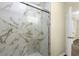Bathroom shower featuring marble style tile and glass door at 3016 Rogan Rd, Orlando, FL 32812
