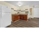 Charming kitchenette with wooden cabinets, open shelving, and modern appliances offers functionality and style at 3016 Rogan Rd, Orlando, FL 32812