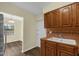 Kitchen area featuring wood cabinets, stainless steel appliances, and a view of the living room at 3016 Rogan Rd, Orlando, FL 32812