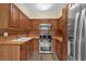 Functional kitchen with wood cabinetry, modern appliances, and tile backsplash at 3016 Rogan Rd, Orlando, FL 32812