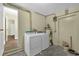 Functional laundry room with washer, dryer, and ample space, providing convenience and utility at 3016 Rogan Rd, Orlando, FL 32812