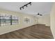 Open living room featuring wood-look flooring, ample natural light, a ceiling fan, and track lighting at 3016 Rogan Rd, Orlando, FL 32812