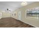 Bright living room features wood-look floors, multiple windows, ceiling fan, and track lighting at 3016 Rogan Rd, Orlando, FL 32812