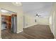 Open concept living and kitchen space with wood-look flooring, neutral paint, and modern appliances at 3016 Rogan Rd, Orlando, FL 32812
