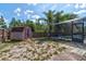 Backyard with a shed, partial grass, and access to the screened in pool at 3237 Newmark Dr, Deltona, FL 32738