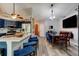 Modern kitchen featuring stainless steel appliances, custom blue cabinets, and granite countertops at 3237 Newmark Dr, Deltona, FL 32738