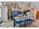 Well-equipped kitchen featuring a breakfast bar, stainless steel appliances, and custom blue cabinetry at 3237 Newmark Dr, Deltona, FL 32738