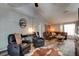 Comfortable living room with leather recliners, a vaulted ceiling, and stylish decor at 3237 Newmark Dr, Deltona, FL 32738