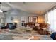 Spacious living room featuring a leather sectional, unique decor, and wood-look flooring at 3237 Newmark Dr, Deltona, FL 32738