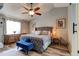 Spacious main bedroom with grey walls, ceiling fan, luxury vinyl flooring, and a tufted grey headboard at 3237 Newmark Dr, Deltona, FL 32738
